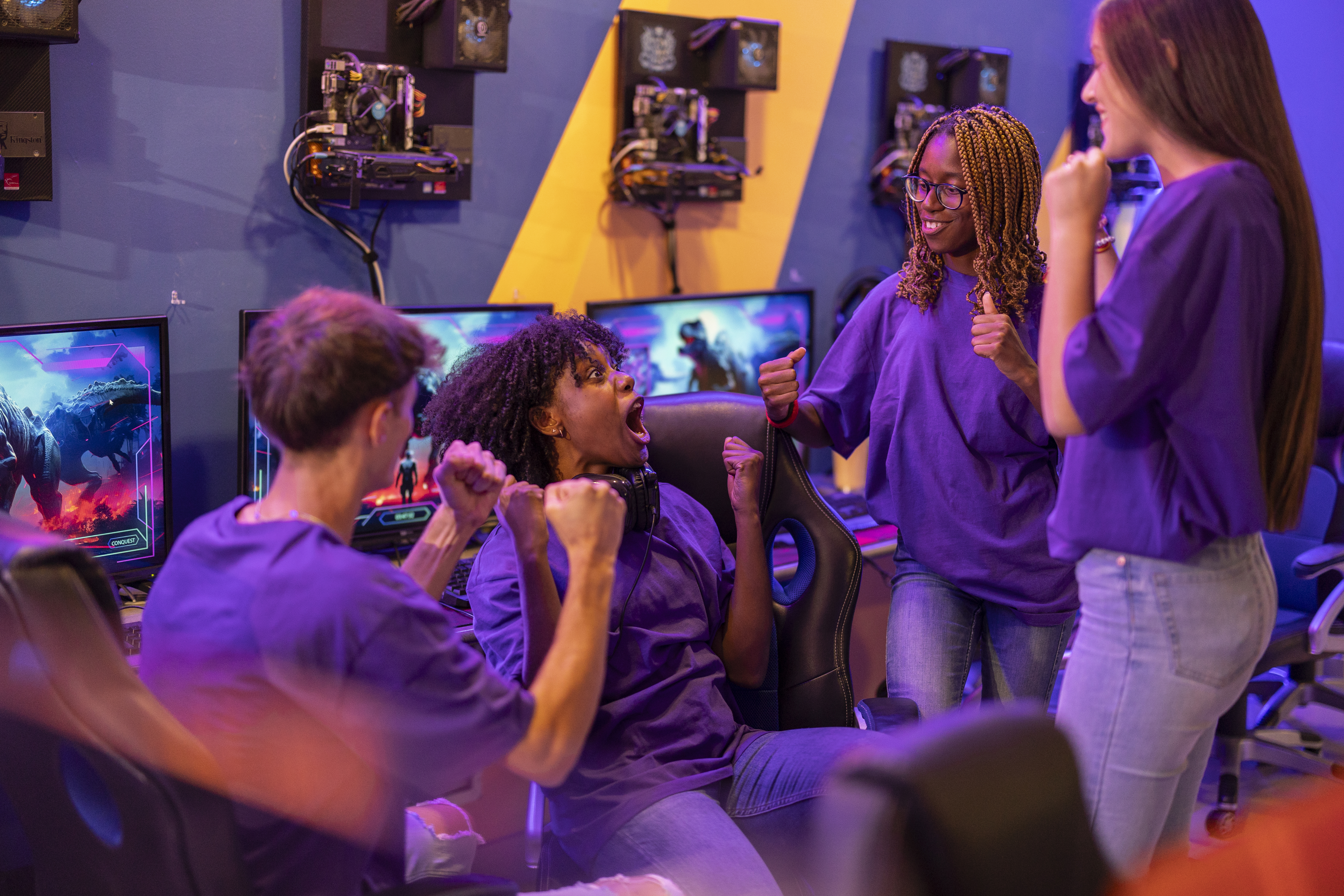 team of young multiracial video game players in league celebrating victory - generation z -